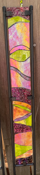 Stained glass garden stake in orange, lime green and purple